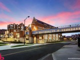 The Phase I building is located at the corner of Andy Holt Avenue and Phillip Fulmer Way adjacent to the Haslam Business Building, the Stokely Management Center, and the existing University Center.  The building is a 5-story 142,000 sf structure that includes a new 50,000 sf bookstore, dining and seating, the Center for Career Development and other offices, a loading dock, and a mechanical penthouse.  A new 28' 0'-wide pedestrian bridge spanning 127'-6" connects the pedestrian mall and the Haslam Business building to “The Hill” and provides an excellent viewpoint on game days to see the Pride of the Southland band.